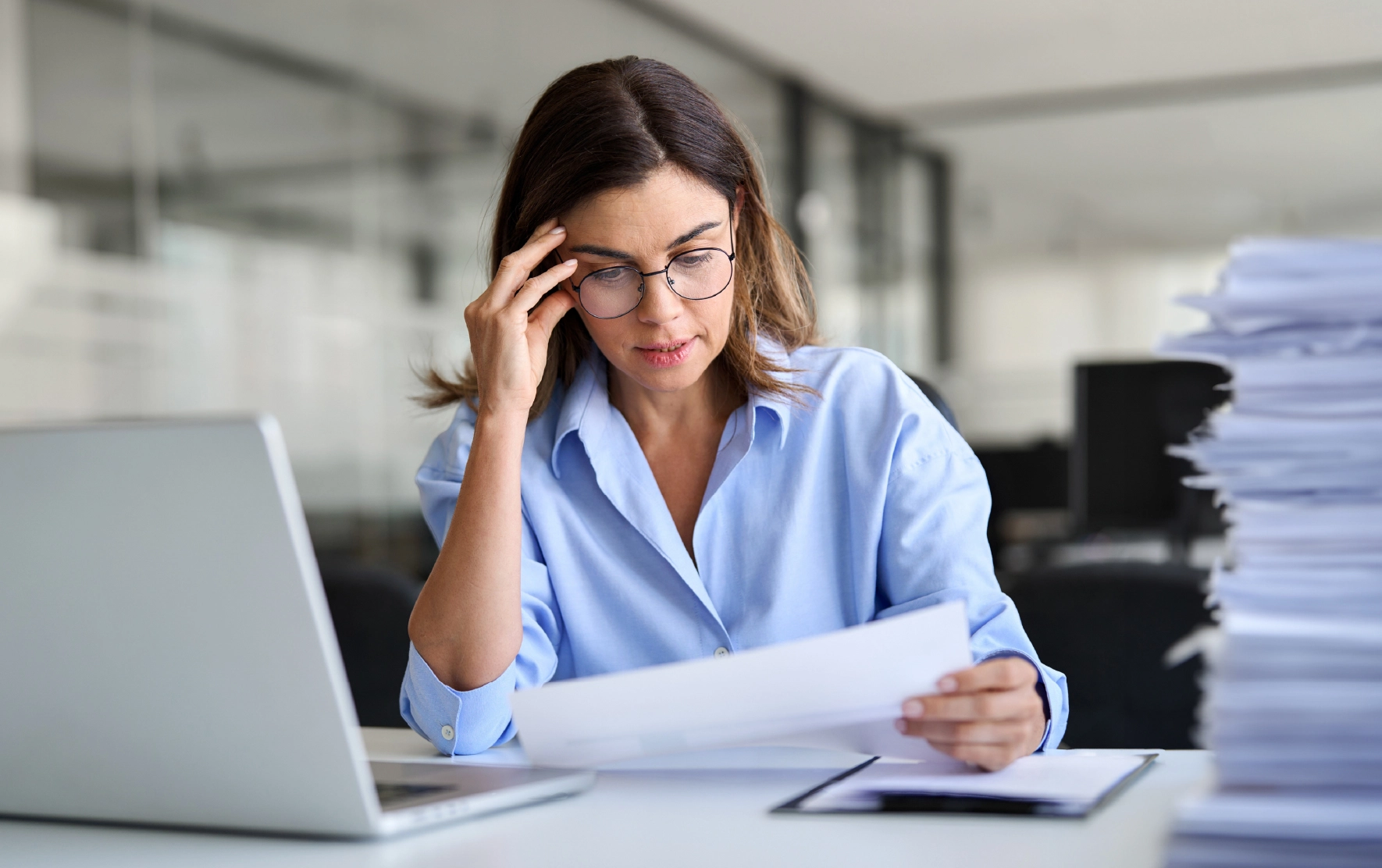 Attorney overwhelmed with legal paperwork, highlighting challenges in managing documents before AI solutions.