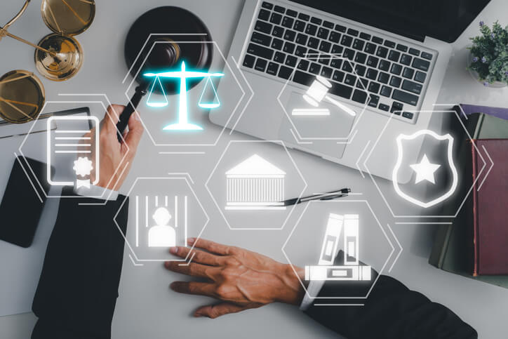 litigation analytics icons hover over a laptop and gavel 