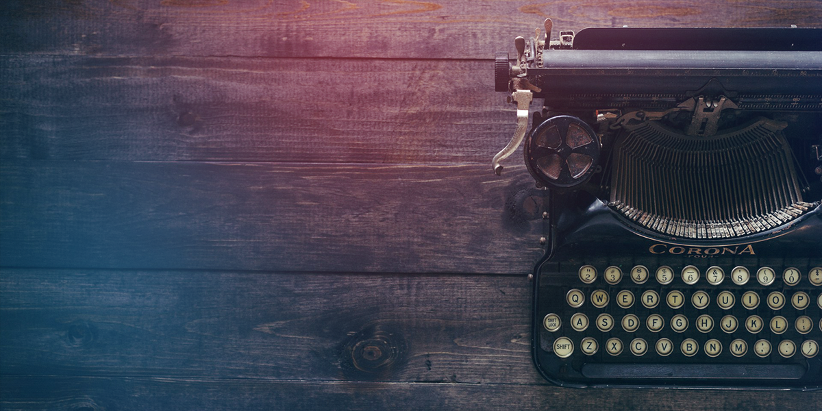 An old-fashioned typewriter on an aged wooden table with a colorful overlay