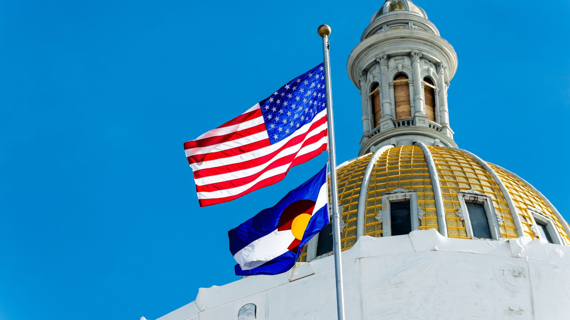 Colorado flag with capitol building in the background