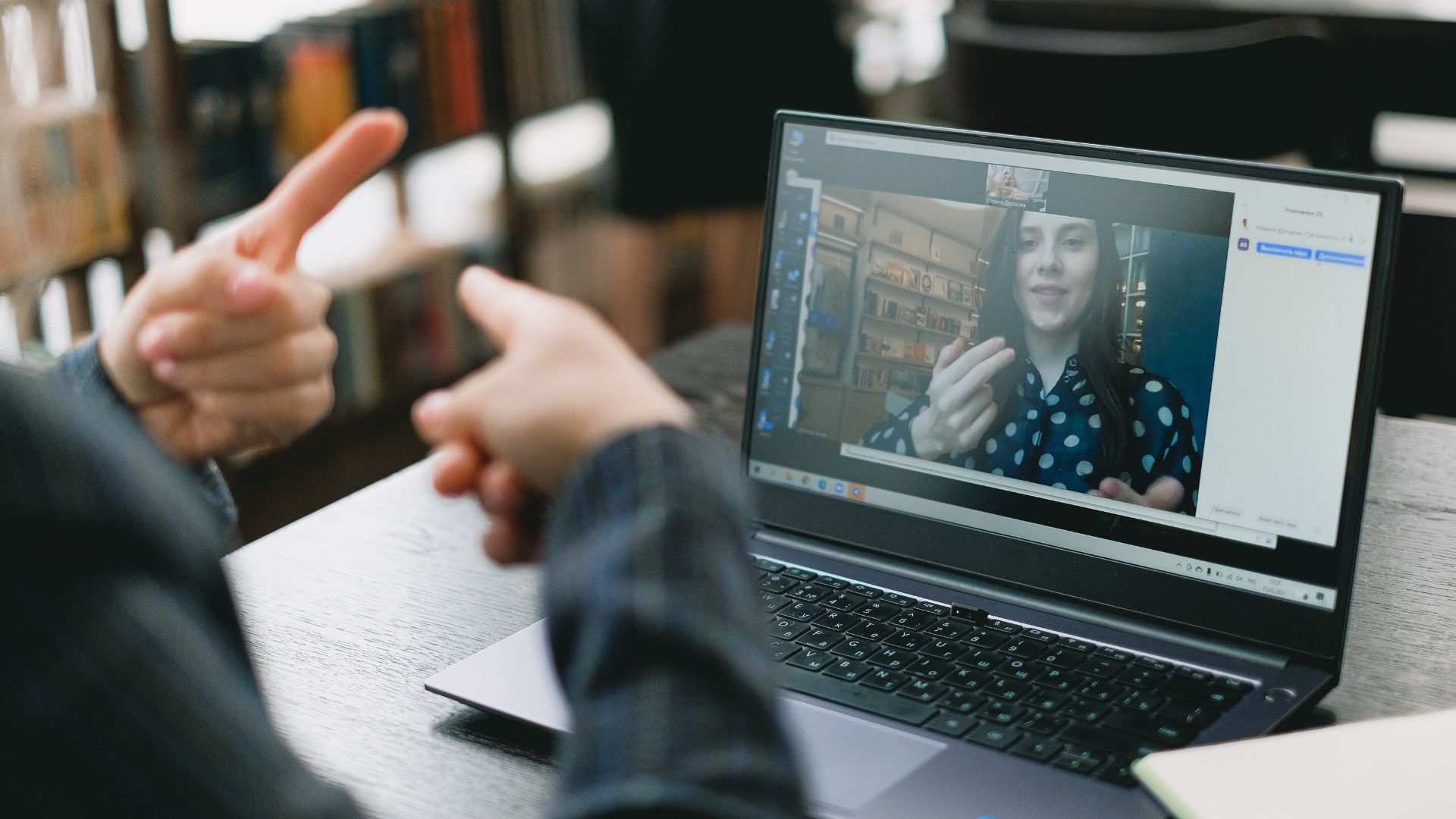 Person on a computer screen using sign language