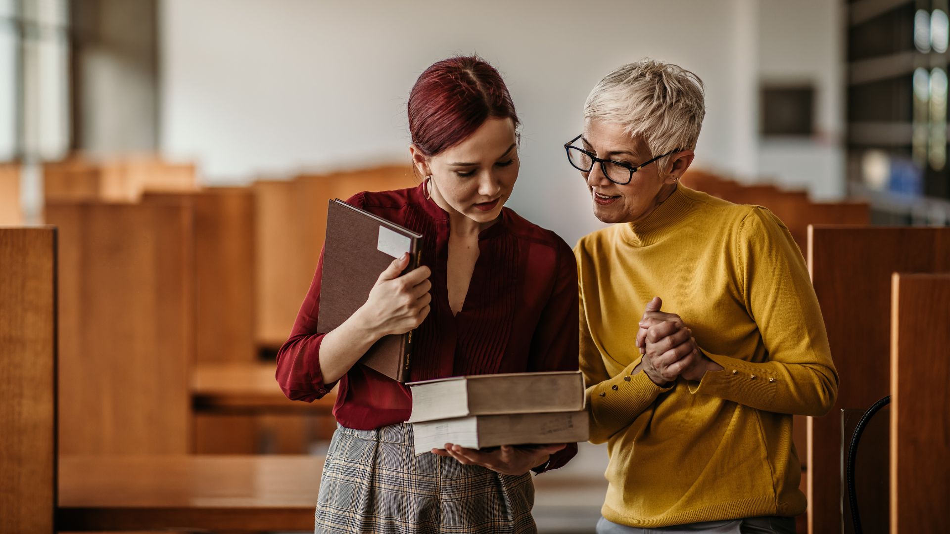 librarian and student looking over a book