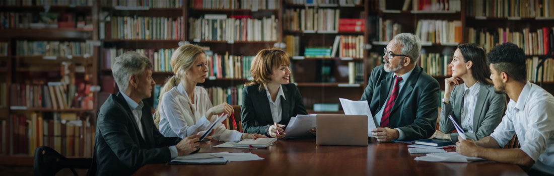 lawyers in boardroom in law department reviewing enterprise legal management software