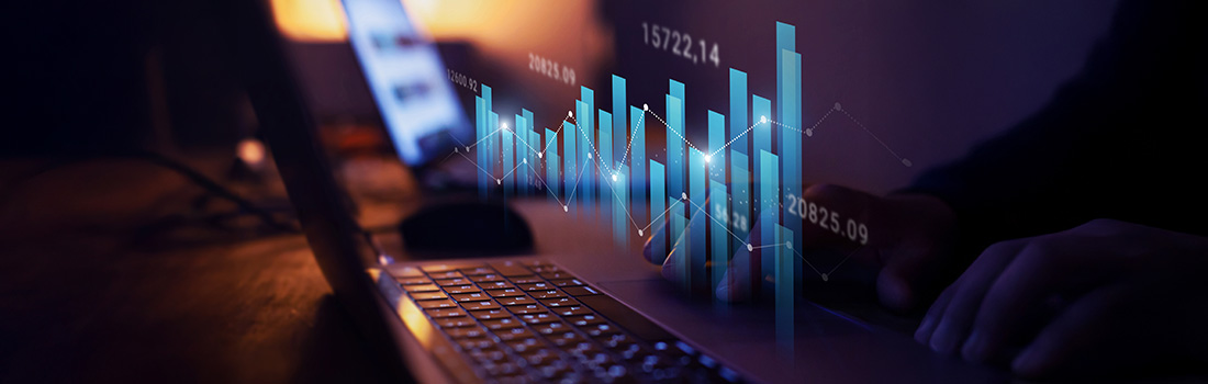 bar graphs floating above laptop to designate importance to benchmark legal spend 